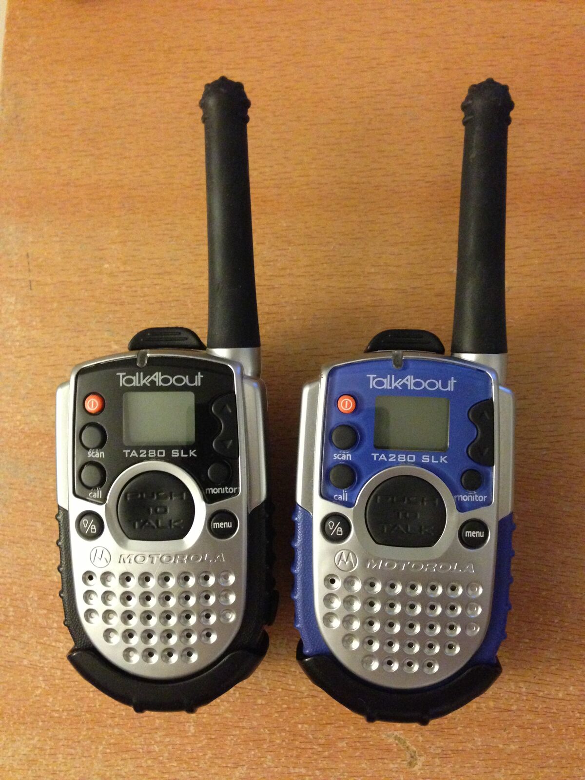 Matched pair of Motorola TalkAbout FRS family walkie-talkies standing side by side