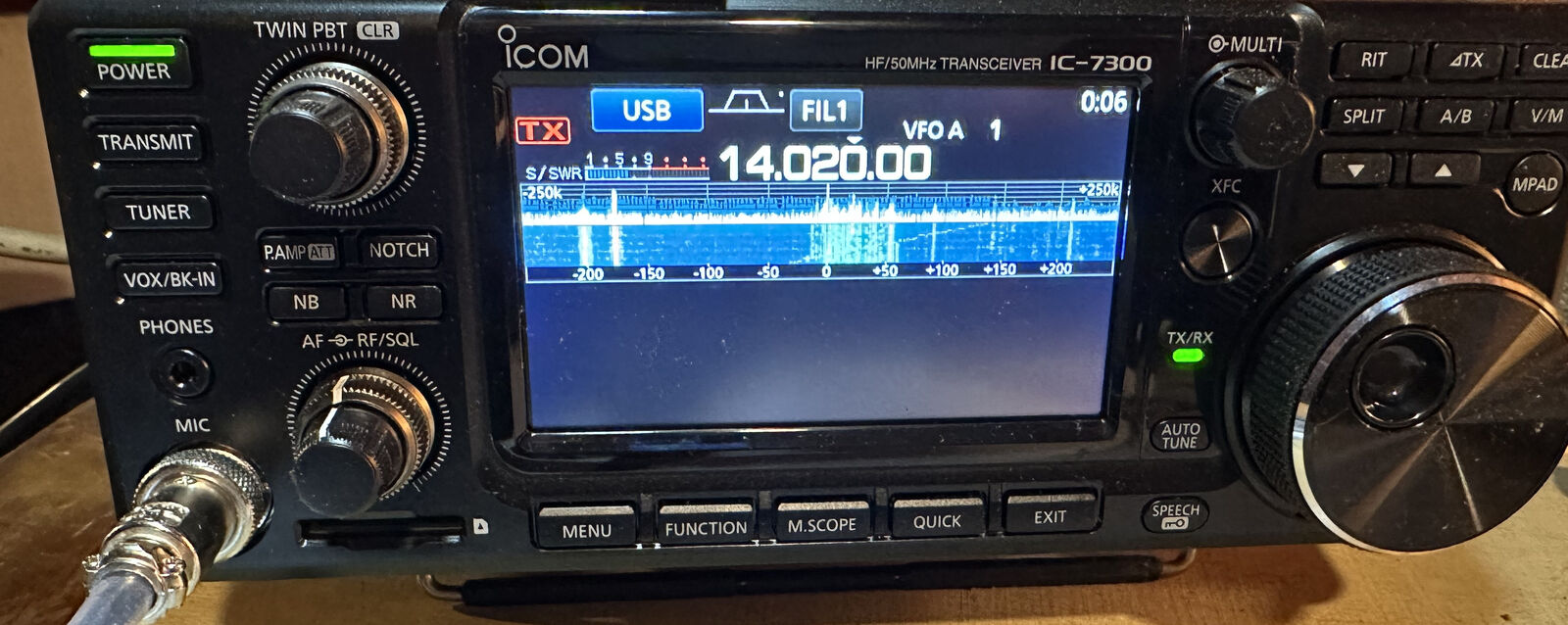Close-up of an Icom IC-7300 HF transceiver front panel with the band scope and waterfall running